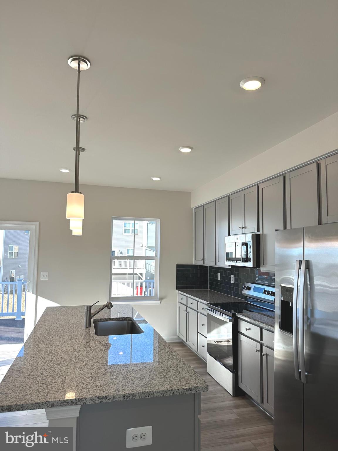 317 Short Br Drive Ranson, WV 25438 - Photo 20 of 41 a kitchen with granite countertop a stove a sink a refrigerator and a granite counter tops