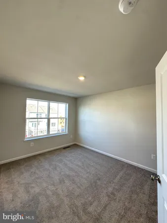 a view of a big room with windows and chandelier fan