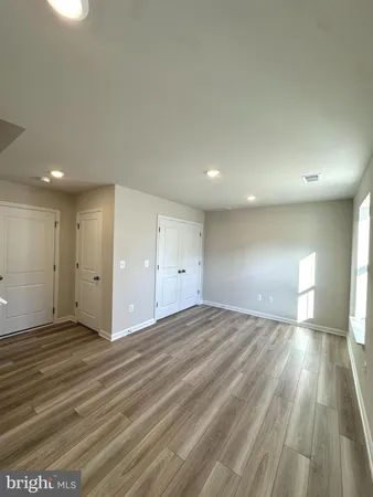 a view of an empty room and wooden floor