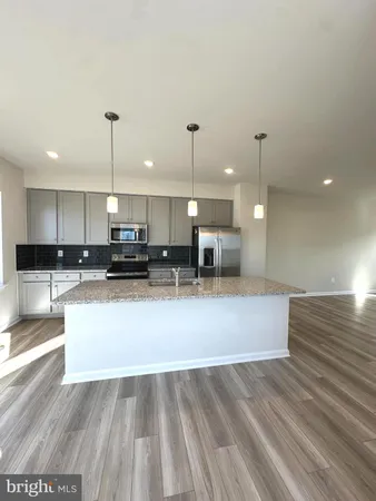 a view of kitchen with kitchen island microwave and stove