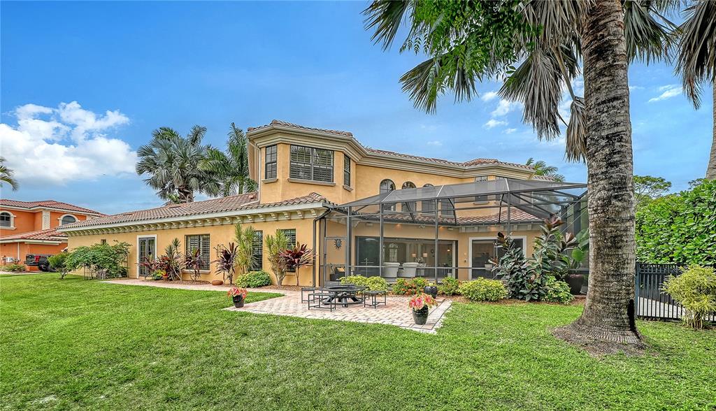 1630 Assisi Drive, Unit 18 Sarasota, FL 34231 - Photo 33 of 42 a front view of a house with porch and garden