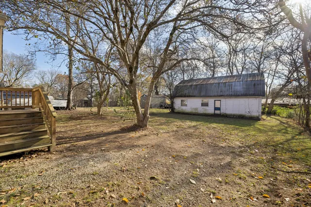a view of a house with a yard covered with snow in the background