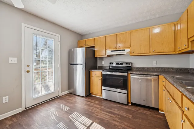 a kitchen with a sink a refrigerator and window