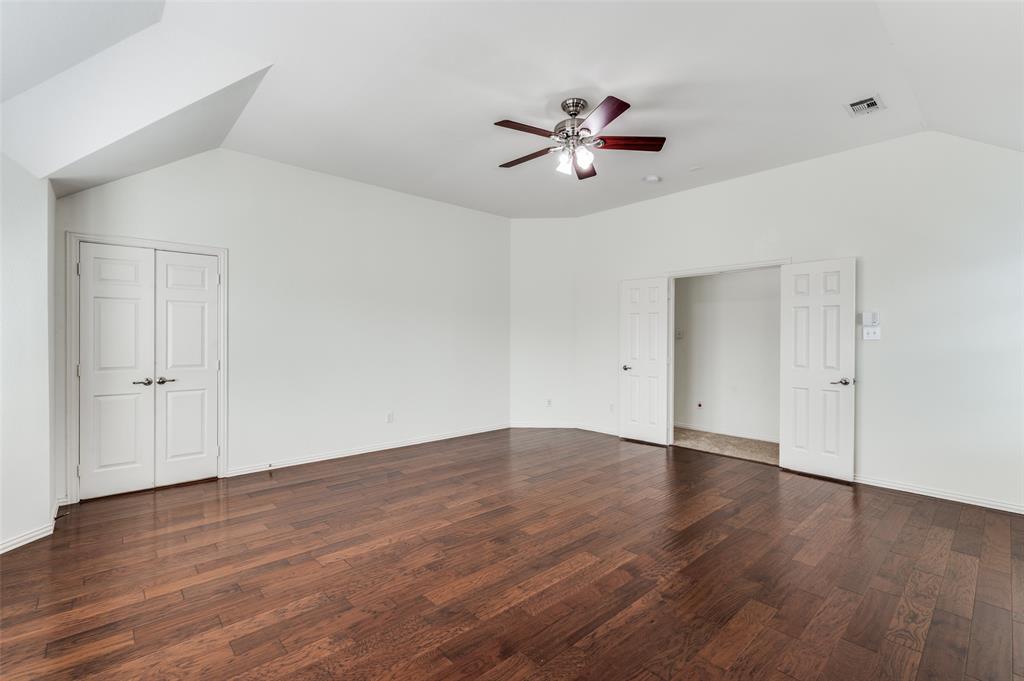 13371 Lime Ridge Drive Frisco, TX 75033 - Photo 13 of 25 Spacious room featuring rich hardwood flooring, a ceiling fan with integrated lighting, and crisp white walls