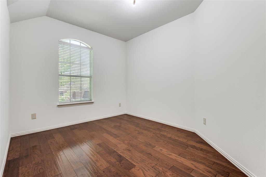 13371 Lime Ridge Drive Frisco, TX 75033 - Photo 15 of 25 This versatile room features rich hardwood flooring, crisp white walls, and an arched window with blinds