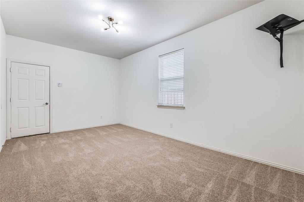 13371 Lime Ridge Drive Frisco, TX 75033 - Photo 19 of 25 Room featuring neutral carpet flooring, white walls, a window with blinds, and a white paneled door