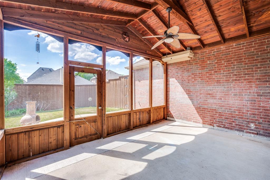 13371 Lime Ridge Drive Frisco, TX 75033 - Photo 23 of 25 The property features a screened-in porch with a wooden frame and exposed brick wall