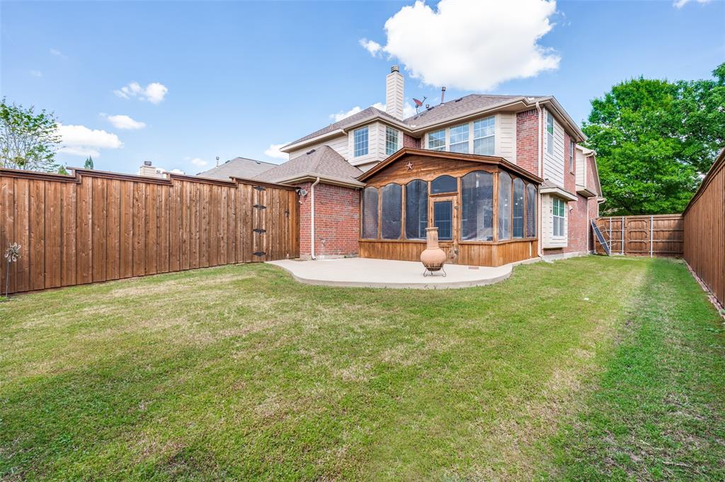 13371 Lime Ridge Drive Frisco, TX 75033 - Photo 24 of 25 The property features a spacious backyard with a well-maintained lawn and a private wooden fence