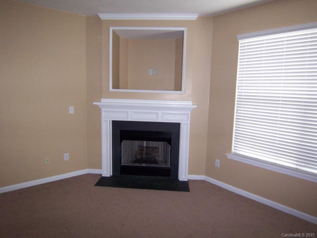 2117 Midnight Blue Lane, Unit 194 Fort Mill, SC 29708 - Photo 2 of 11 a living room with a fireplace and a window