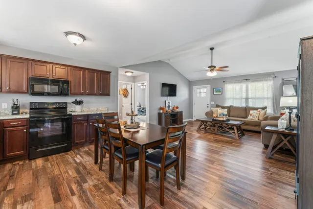 a view of a dining room with furniture and wooden floor