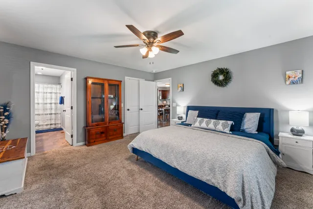 a bedroom with a bed and a chandelier