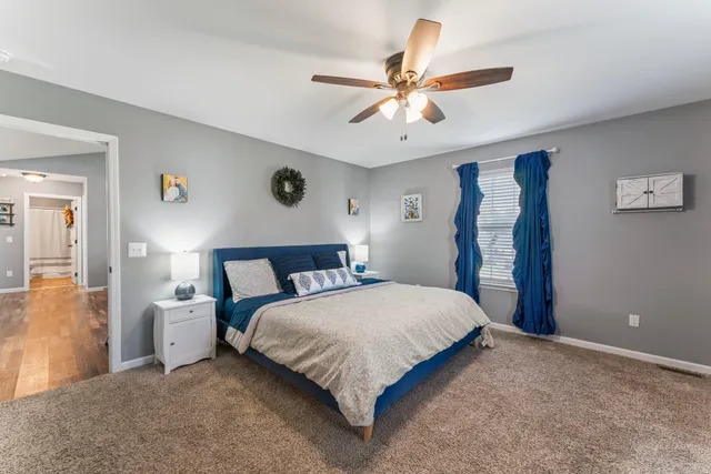 a bedroom with a large bed and a chandelier
