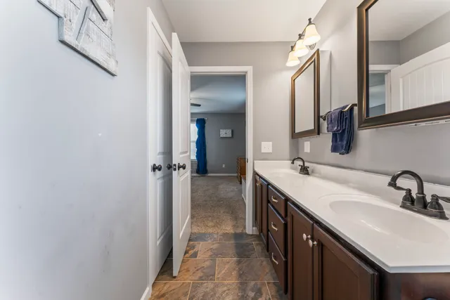 a bathroom with a double vanity sink and mirror