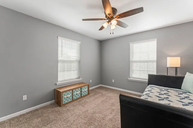 a bedroom with furniture and a window