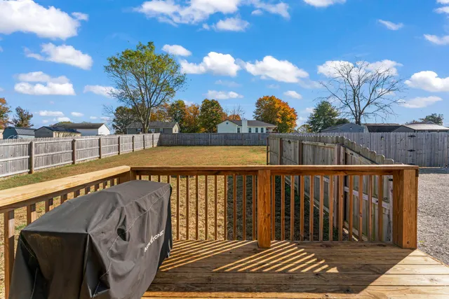 a view of balcony with wooden floor and fence