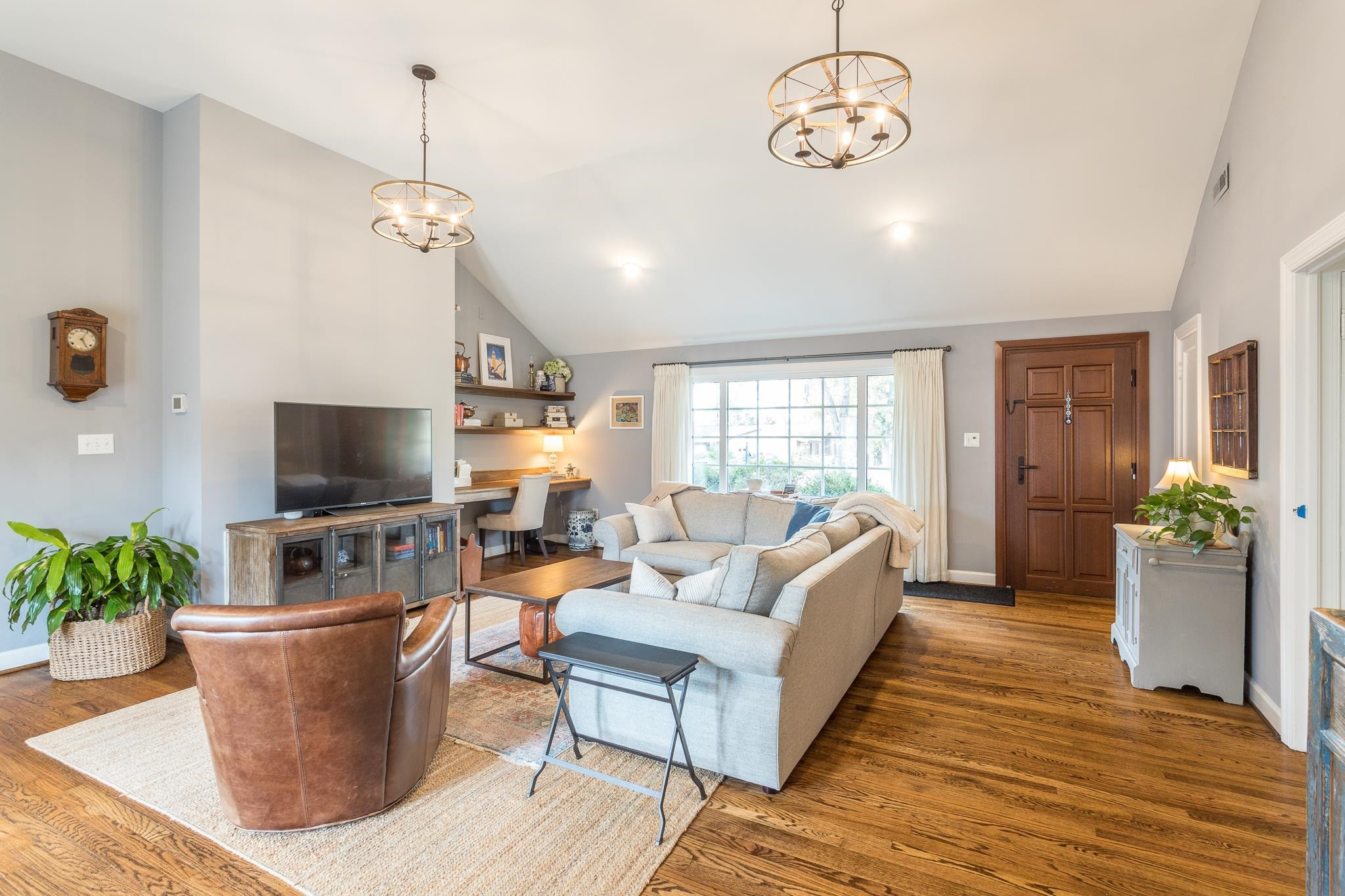 1410 Chester Road Raleigh, NC 27608 - Photo 3 of 10 a living room with furniture a flat screen tv and a window