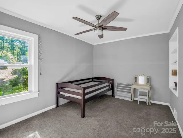 a bedroom with a bed and a ceiling fan