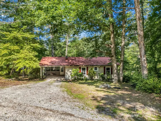 a view of a lush green hillside and a building in the background