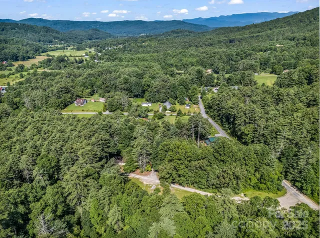a view of a big yard with lots of green space and mountain view