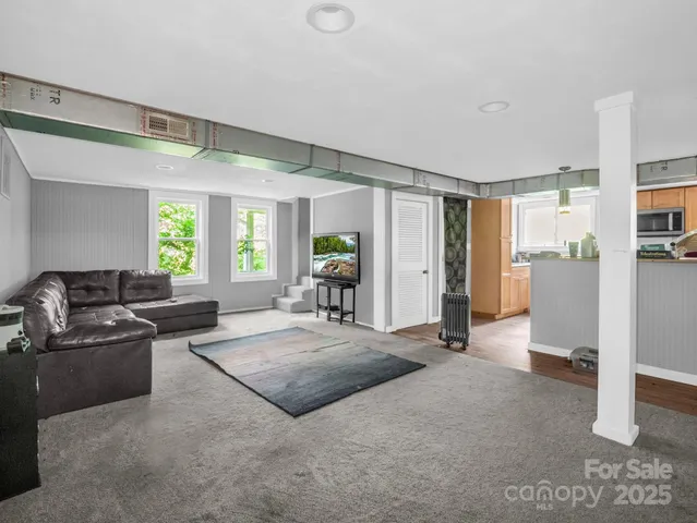 a living room with furniture and a ceiling fan