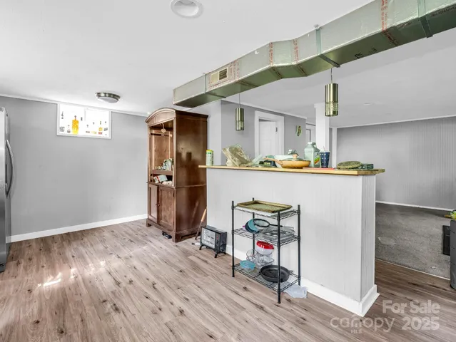 a view of a workspace with wooden floor