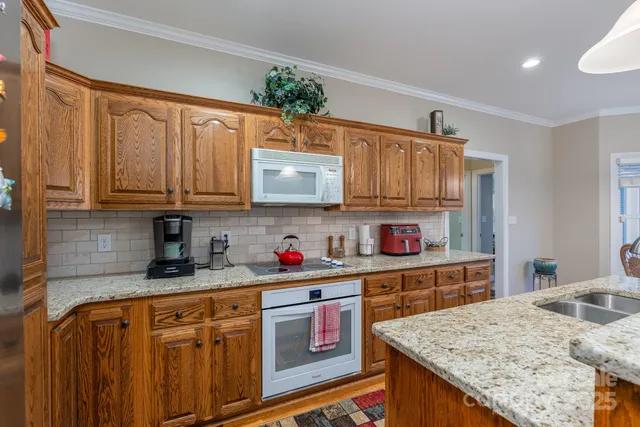 a kitchen with stainless steel appliances granite countertop a stove and cabinets