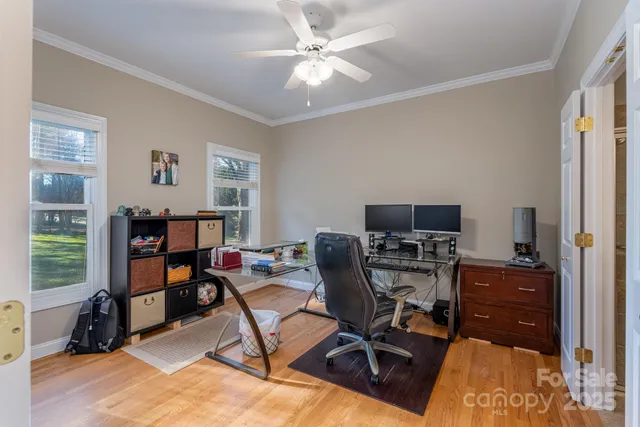 a view of a workspace with furniture and a window