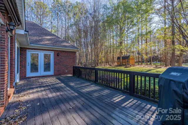 a view of backyard with deck and wooden floor