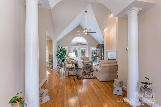 a living room with furniture and a chandelier