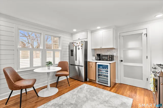 a living room with furniture and a kitchen view