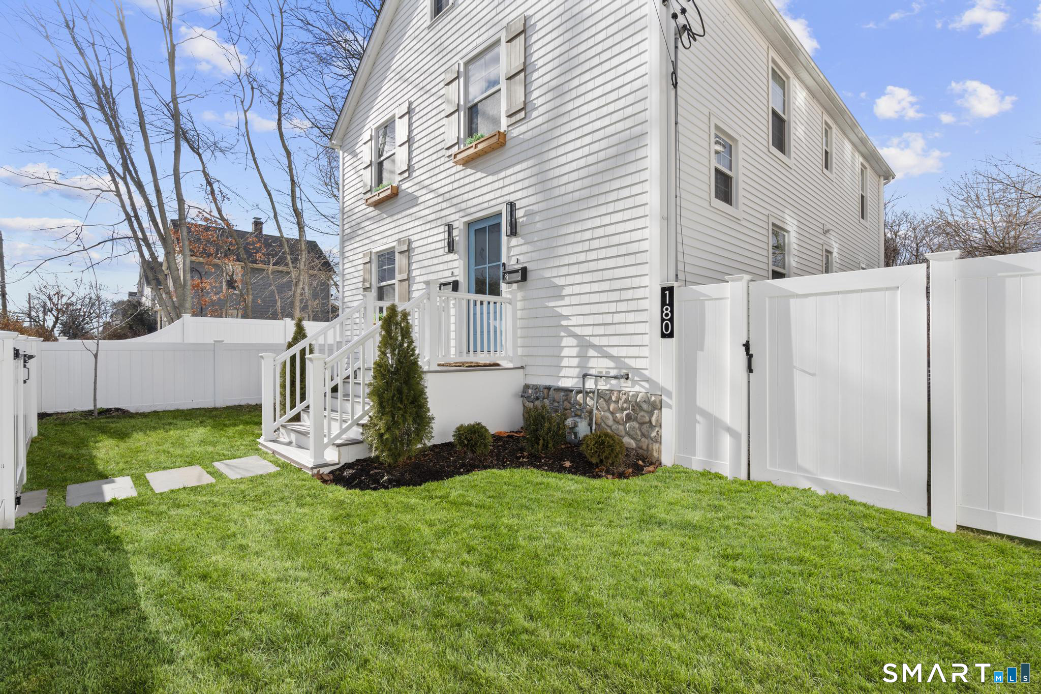 180 Ruane Street, Unit 1 Fairfield, CT 06824 - Photo 2 of 20 a backyard of a house with lots of green space