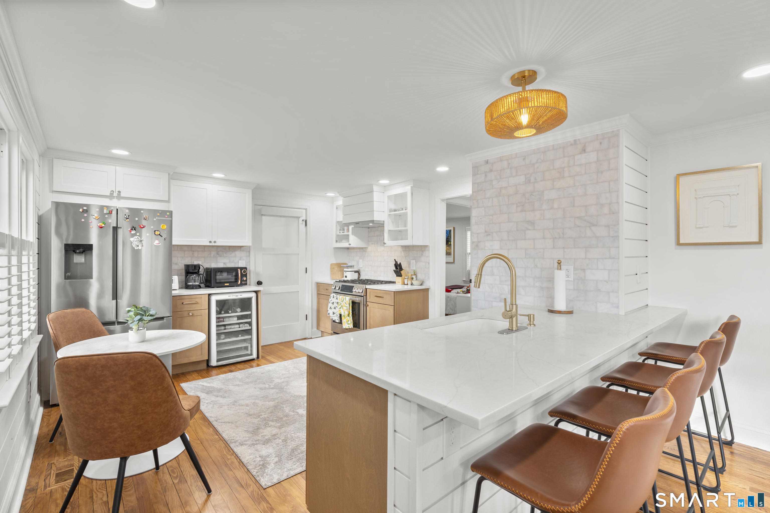180 Ruane Street, Unit 1 Fairfield, CT 06824 - Photo 7 of 20 a kitchen with stainless steel appliances granite countertop a stove top oven a sink dishwasher and white cabinets with wooden floor