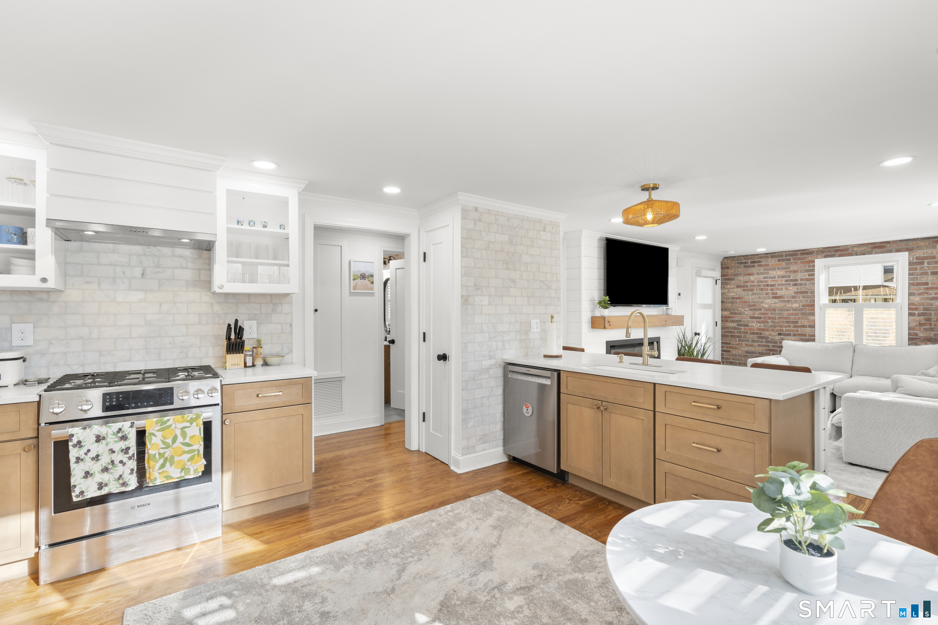 180 Ruane Street, Unit 1 Fairfield, CT 06824 - Photo 8 of 20 a kitchen with stainless steel appliances kitchen island granite countertop a sink and a stove