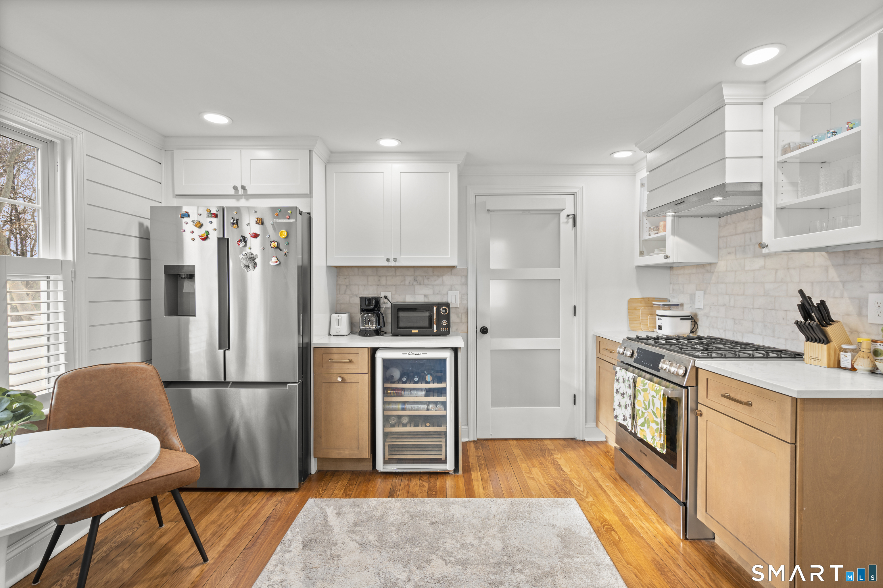 180 Ruane Street, Unit 1 Fairfield, CT 06824 - Photo 10 of 20 a kitchen with stainless steel appliances granite countertop a refrigerator stove and sink