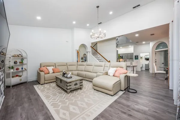 a living room with furniture and wooden floor