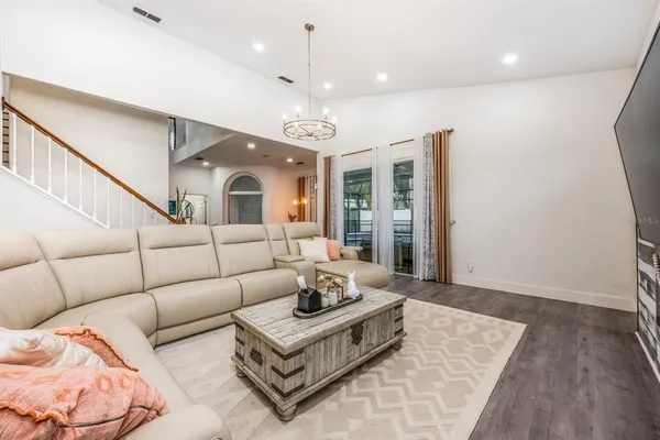 a living room with furniture and a chandelier