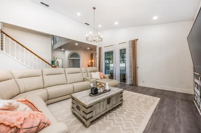a living room with furniture and a chandelier