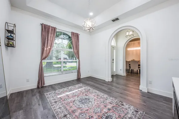 a view of a livingroom with wooden floor and a window