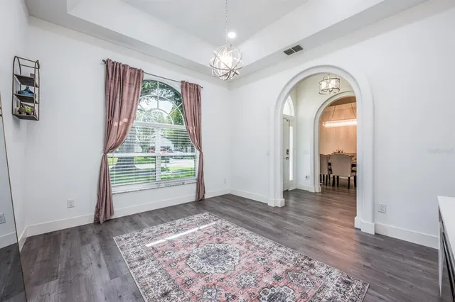 a view of a livingroom with wooden floor and a window