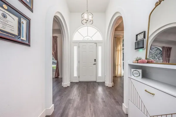 a view of livingroom with hallway and wooden floor