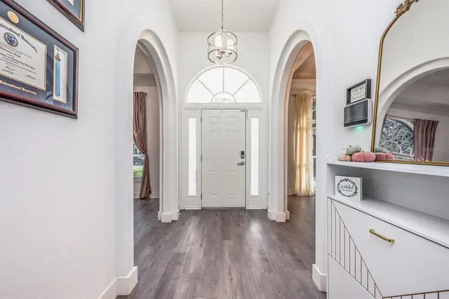 a view of livingroom with hallway and wooden floor