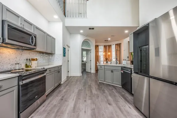 a view of a kitchen with a sink stove and refrigerator