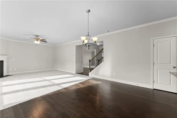 a view of a room with wooden floor chandelier and entryway