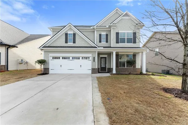 a front view of a house with a yard and garage