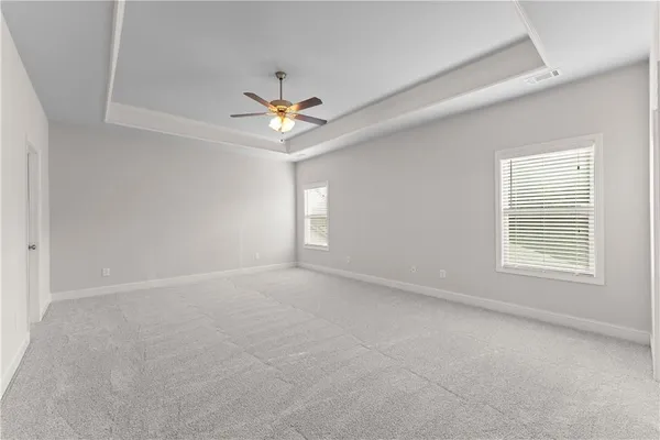 an empty room with a window and a ceiling fan