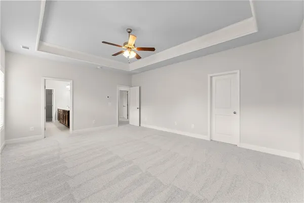 a view of an empty room with a ceiling fan