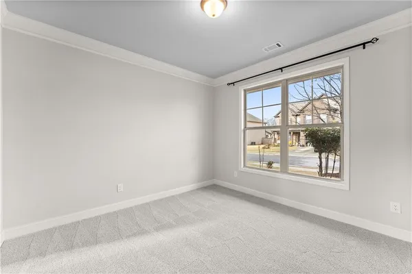 an empty room with windows and closet