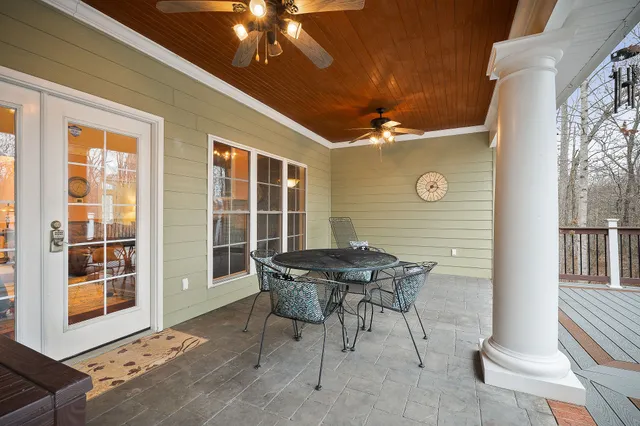 a view of a house with backyard and sitting area