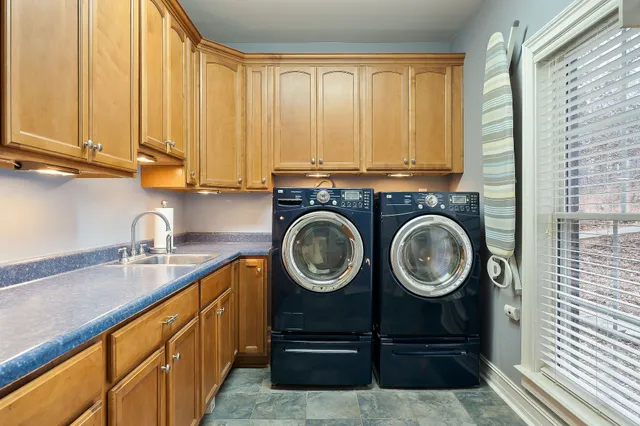 a bathroom with a sink a mirror and cabinets