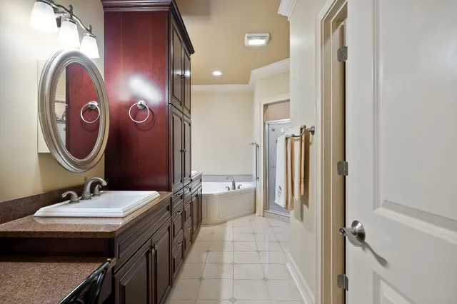 a spacious bathroom with a sink a mirror and a shower